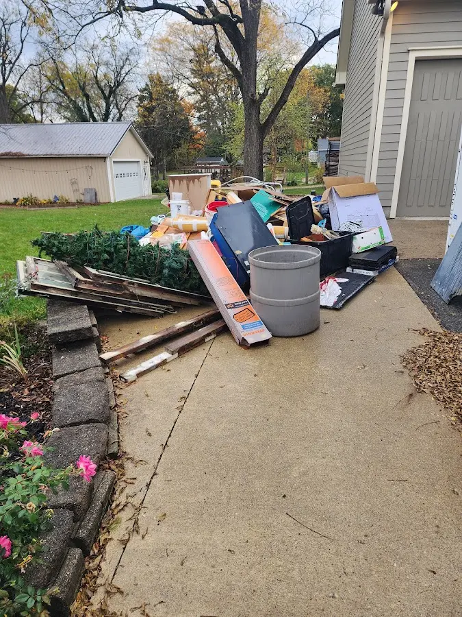 Dumpster being loaded with debris for Residential Dumpster Rental in Concord